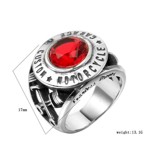 Detail of vintage steel motorcycle ring with a large red ruby gemstone and custom engraving