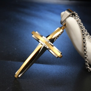 Two-tone stainless steel layered cross pendant for men with silver chain on hand display