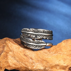 Detailed macro view of vintage feather open ring with intricate engraved silver textures