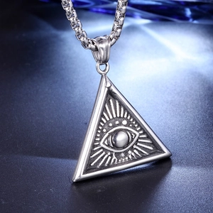 Detailed view of punk triangle all-seeing eye pendant with radial texture on a link chain