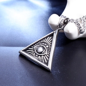 Macro shot of silver punk triangle eye pendant with relief detail on stainless steel chain
