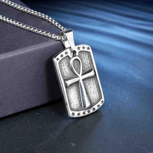 Macro detail of silver stainless steel Ankh pendant with embossed star texture and box chain