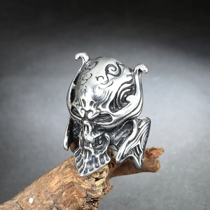 Men's punk stainless steel skull ring with vintage tribal engravings on weathered wood