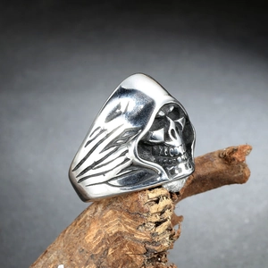 Gothic hooded reaper skull ring in silver stainless steel displayed on natural wood