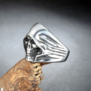 Gothic hooded skull ring in vintage silver finish on a rustic wooden stand