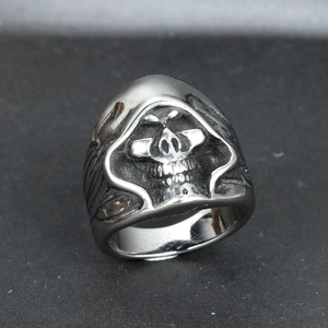 Macro shot of gothic hooded skull ring in vintage stainless steel with engraved details