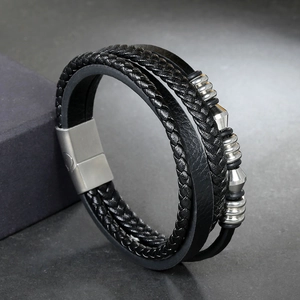 Close-up of multilayer leather bracelet featuring silver metal beads and magnetic clasp