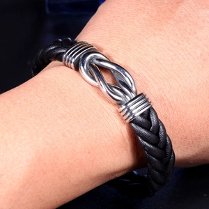 Men's retro braided black leather bracelet featuring a silver interlocking knot buckle