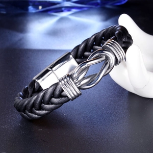 Detail of men's black braided leather bracelet with silver infinity knot on a hand display
