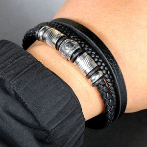 Macro detail of multi-layer men's leather bracelet with vintage engraved metal beads
