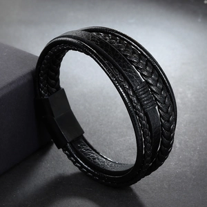 Detailed macro of black braided leather bracelet with matte black magnetic clasp