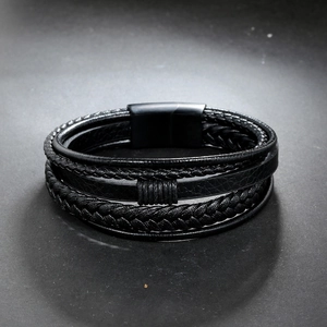 Close-up of multi-layer black leather braided bracelet with matte magnetic steel clasp