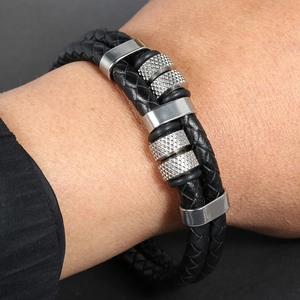 Close-up of double-strand braided black leather bracelet with silver stainless steel beads