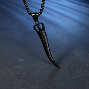 Detail of a matte black horn pendant with a silver crown top on a box chain necklace