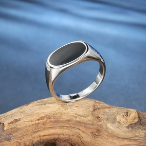 Polished titanium steel ring for men with a smooth black oval epoxy resin inlay