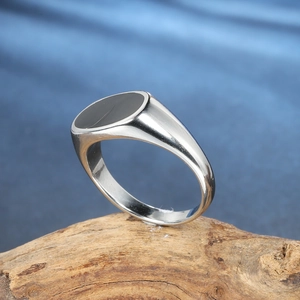 Minimalist silver stainless steel signet ring for men featuring a black oval stone inlay
