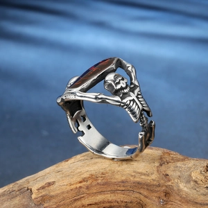 Detailed side view of punk vampire bat skull ring with a deep reddish-brown gemstone