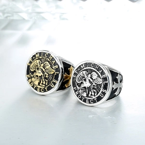 Detail of St. Michael signet rings with embossed angel and religious engravings