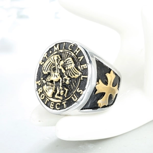 Detailed macro view of vintage St. Michael signet ring with gold cross side pattern