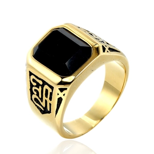 Close-up of vintage gold steel men's signet ring with a large rectangular black stone