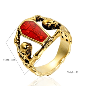 Gothic punk coffin ring in vintage gold finish with skull motifs for men, 45-degree angle