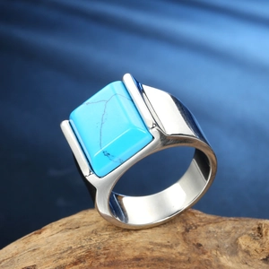 Detailed shot of square turquoise stone set in a heavy stainless steel ring for men