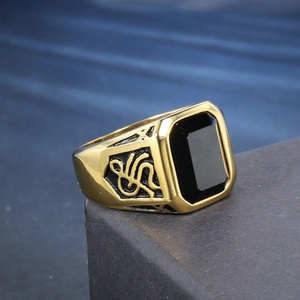 Vintage gold and black stainless steel men's ring with a large rectangular black gemstone