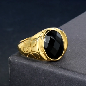 Vintage stainless steel ring featuring a black faceted gemstone and gold floral engraving