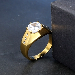 Golden stainless steel ring featuring a large round zircon and side stone accents