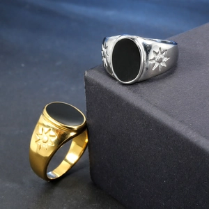 Vintage stainless steel signet ring with black oval stone and engraved star patterns