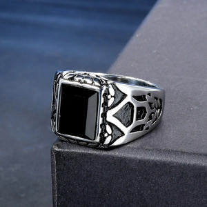 Detail of vintage punk men's ring showing ornate carvings and black onyx gemstone