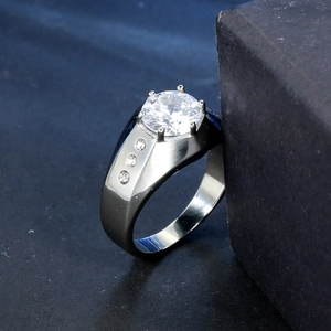 Polished stainless steel zircon ring with six-prong crown setting on dark background