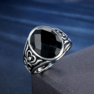 Vintage oxidized silver men's ring featuring a large oval black onyx stone and floral motifs