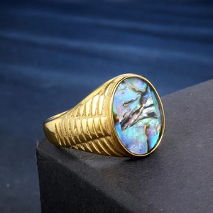 Golden signet ring with oval abalone shell inlay and striped engraving on band