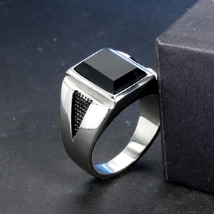Men's gothic punk silver ring featuring a rectangular black onyx stone on stone background