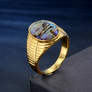 Retro gold spinner ring featuring oval abalone shell inlay and textured band
