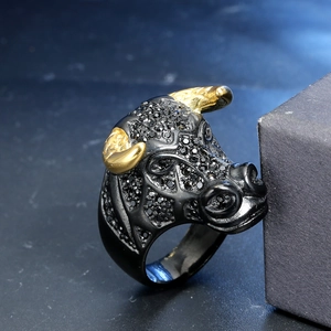 Détail d'une bague tête de taureau punk avec cristaux noirs et cornes dorées