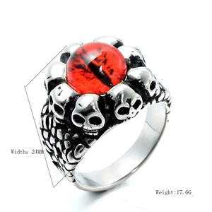 Macro detail of gothic skull ring with red evil eye stone in aged stainless steel finish