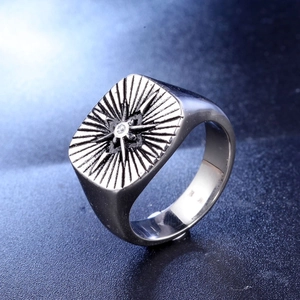 Macro view of men's titanium steel ring featuring a square face and starburst pattern
