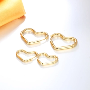 Ensemble de boucles d'oreilles créoles cœur minimalistes dorées pour femme sur blanc