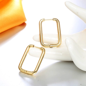 Polished 18K gold plated U-shaped rectangular hoop earrings on a ceramic display