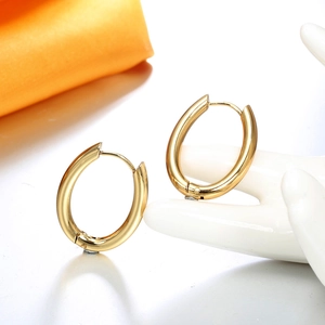 Minimalist high-polish golden U-shape hoop earrings displayed on a white hand model