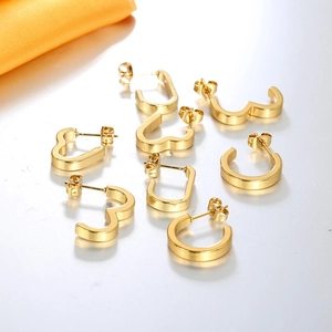 Flat lay of 8-piece 18K gold-plated geometric earring set including heart and hoop shapes