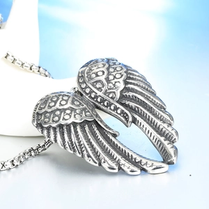 Detailed close-up of retro angel wings pendant with intricate feather texture on box chain