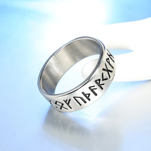 Macro shot of brushed stainless steel ring featuring engraved Nordic Viking runes