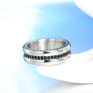 Close-up of a silver titanium steel ring featuring a central row of black zircon stones
