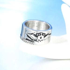 Close-up of punk wing and crown relief on stainless steel ring with zircon stones