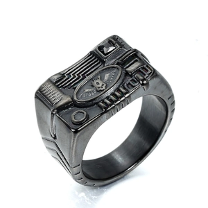Industrial punk style matte black ring with winged skull relief and black zircon stone