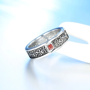 Vintage silver ring featuring a square red gemstone and detailed woven texture patterns
