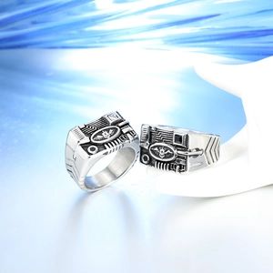 Macro detail of gothic punk rings with circuit texture and winged skull motif